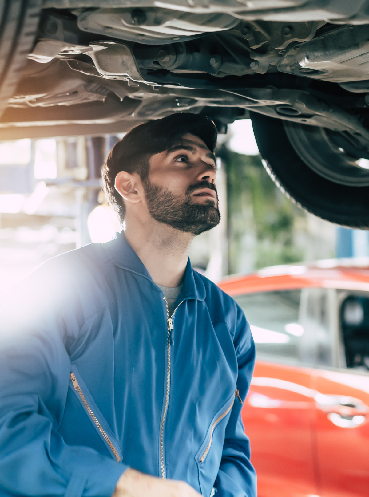 Mechanic checking under a vehicle - MOT and Servicing Redditch